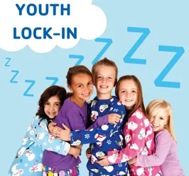 five children in pajamas doing a group hug.