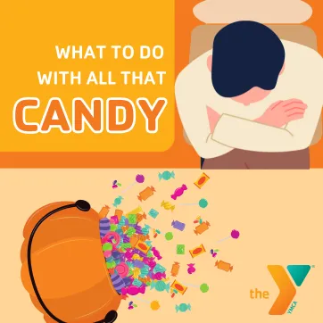 A dad looking at a pile of Halloween candy on the table. 
