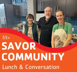 3 people cooking in the teaching kitchen.