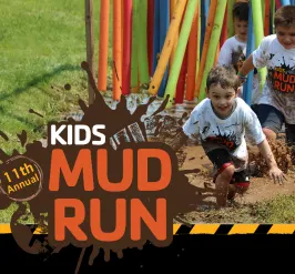 A group of kids running in a mud puddle. 11th annual kids mud run. 