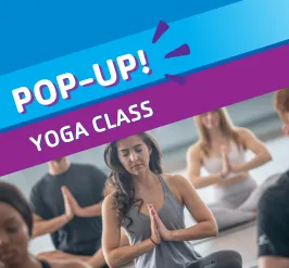A group sitting on yoga mats. 
