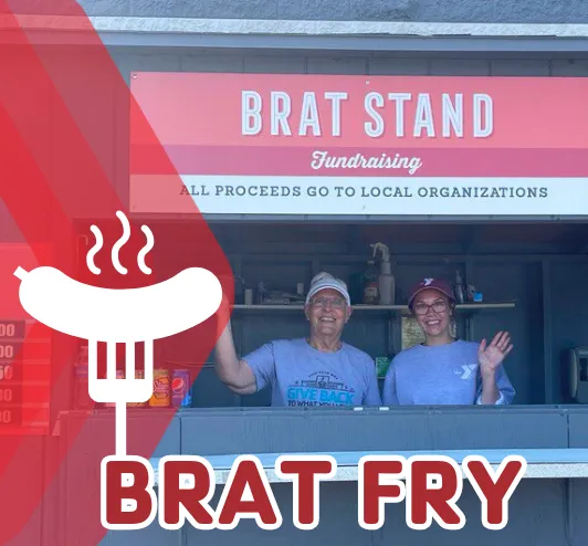Two volunteers serving up brats at the Festival Foods brat barn.