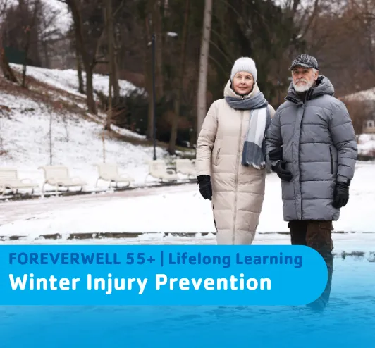 An older couple walking in the snow.