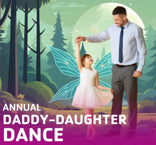 A little girl in a dress and fairy wings dancing with her dad.