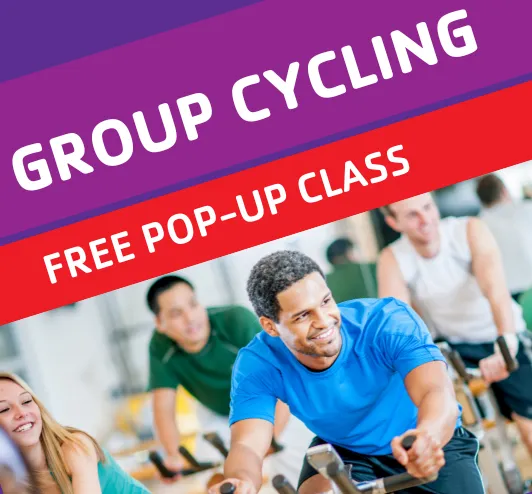 Group Cycling: a free pop-up class. A man on an exercise bike.