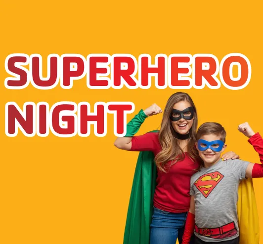 A mom and son posing in their superhero costumes.