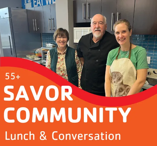 3 people cooking in the teaching kitchen.