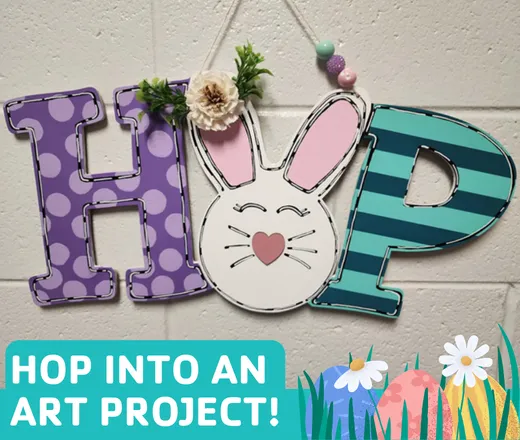 A painted wooden sign reading "hop" with a bunny.