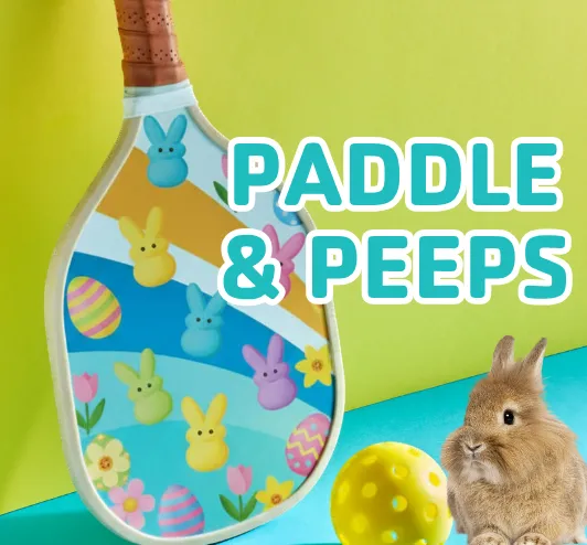 A pickleball with peeps on it next to a pickleball and a bunny.