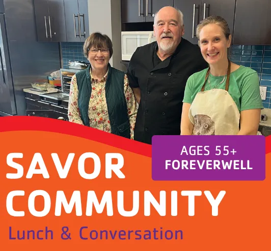 3 people cooking in the teaching kitchen.
