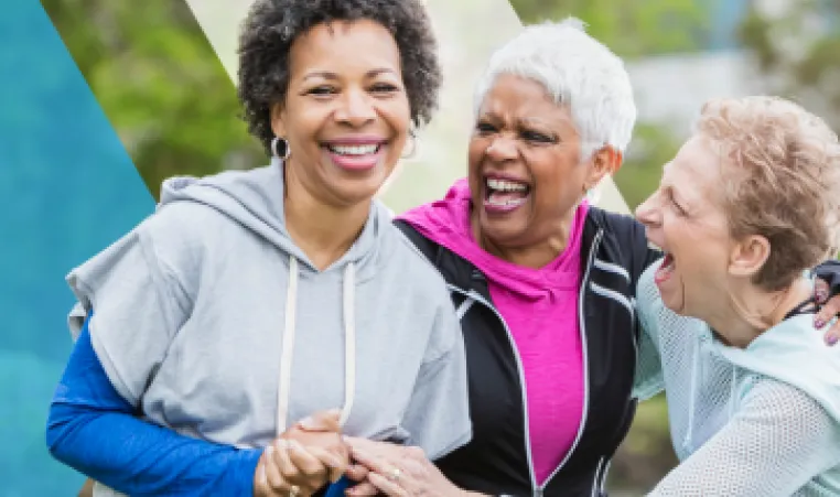 A group of older women chatting and laughing together.