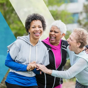 A group of older women chatting and laughing together.