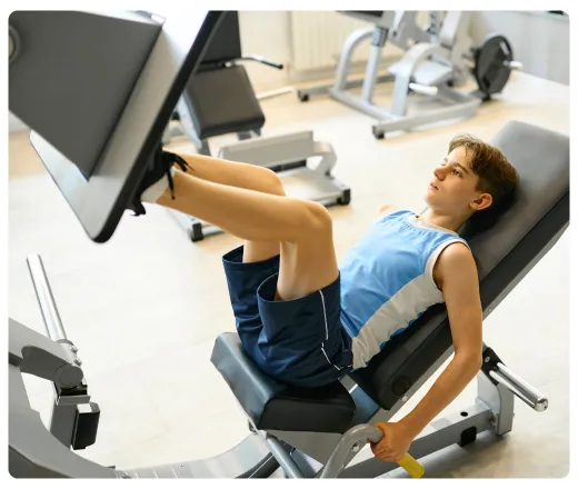 a teen boy doing leg exercises.