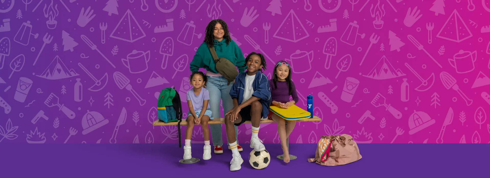 A group of kids with supplies for camp- a backpack, soccer ball, goggles.