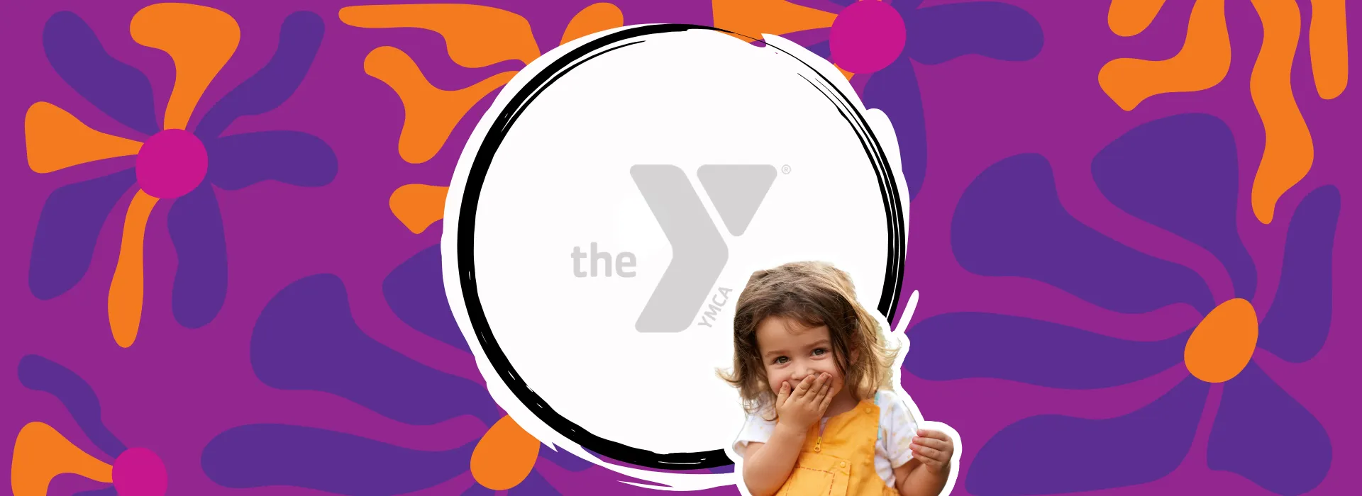 A little girl smiling against a floral background.