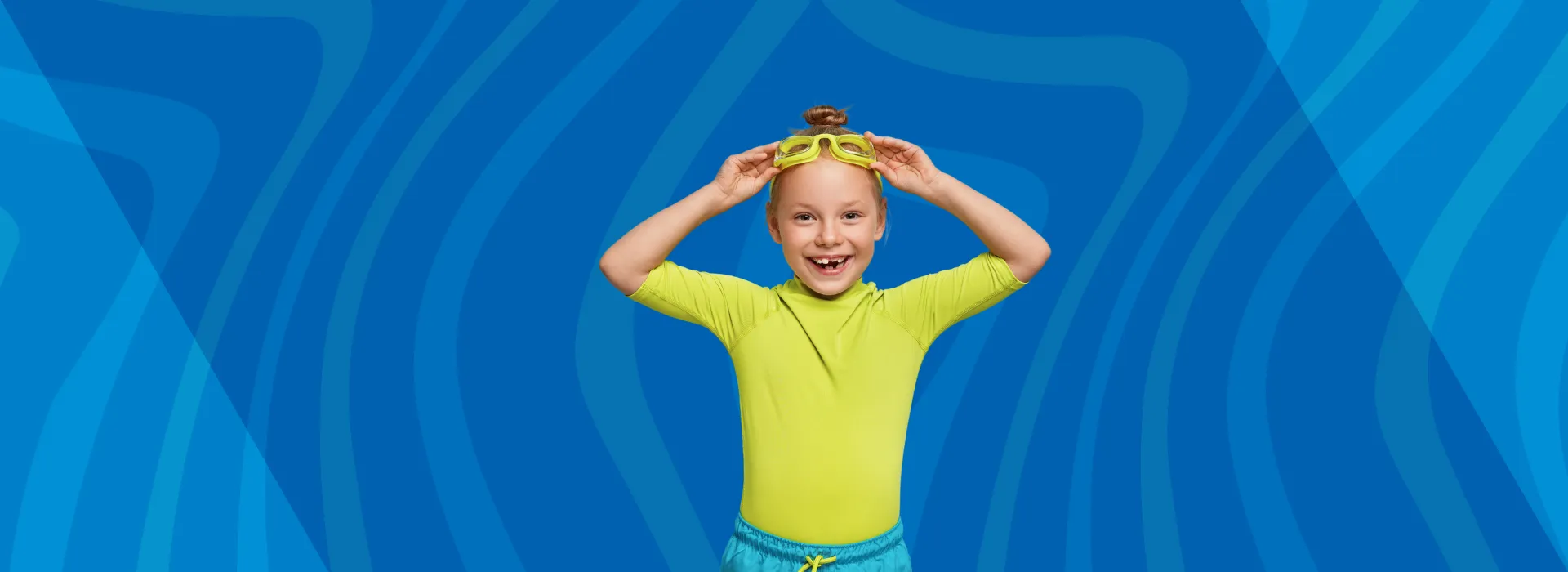 A little girl in swim goggles.